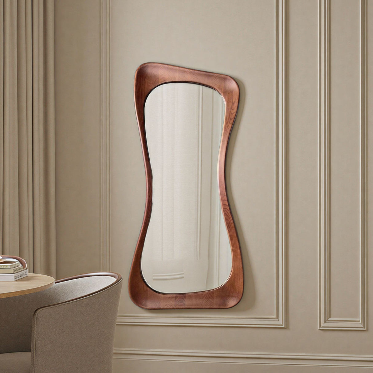 Wavy mirror with wooden frame on a beige paneled wall