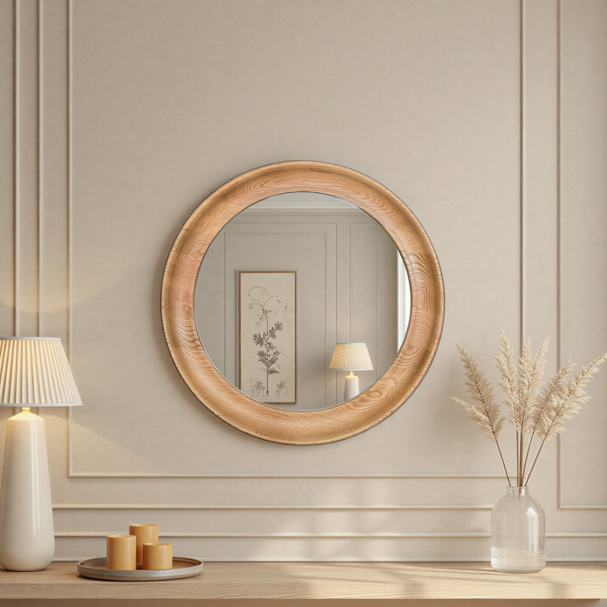 Round wooden mirror on a wall with decorative items below.