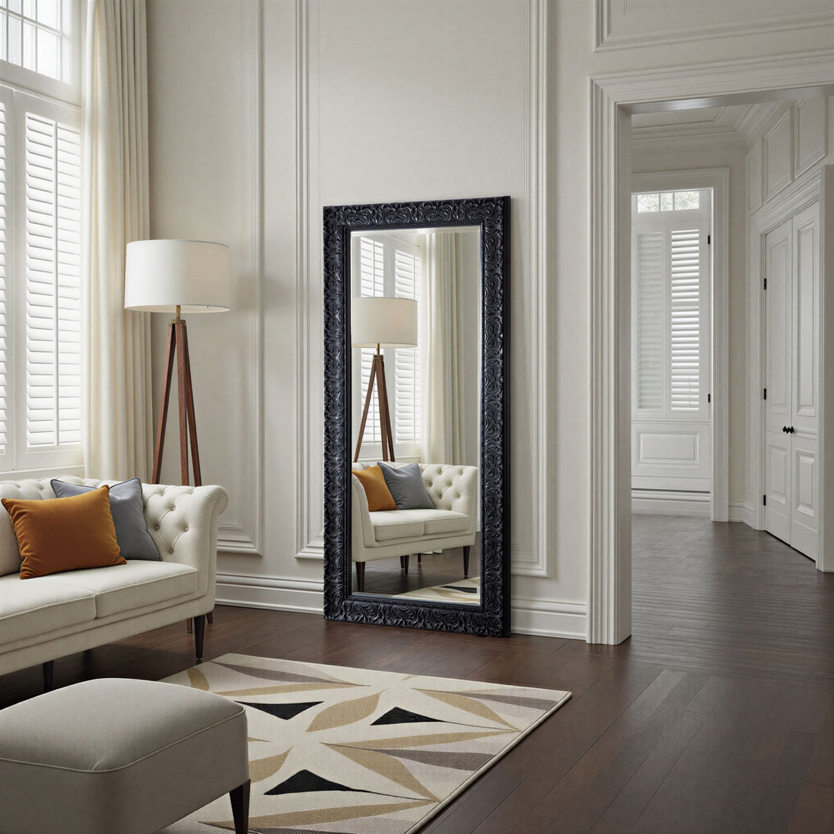 Living room with a large decorative mirror, sofa, and lamp.