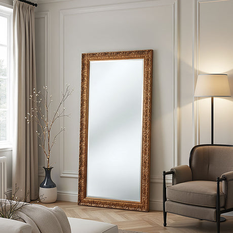 Decorative floor mirror with gold frame in a living room setting.