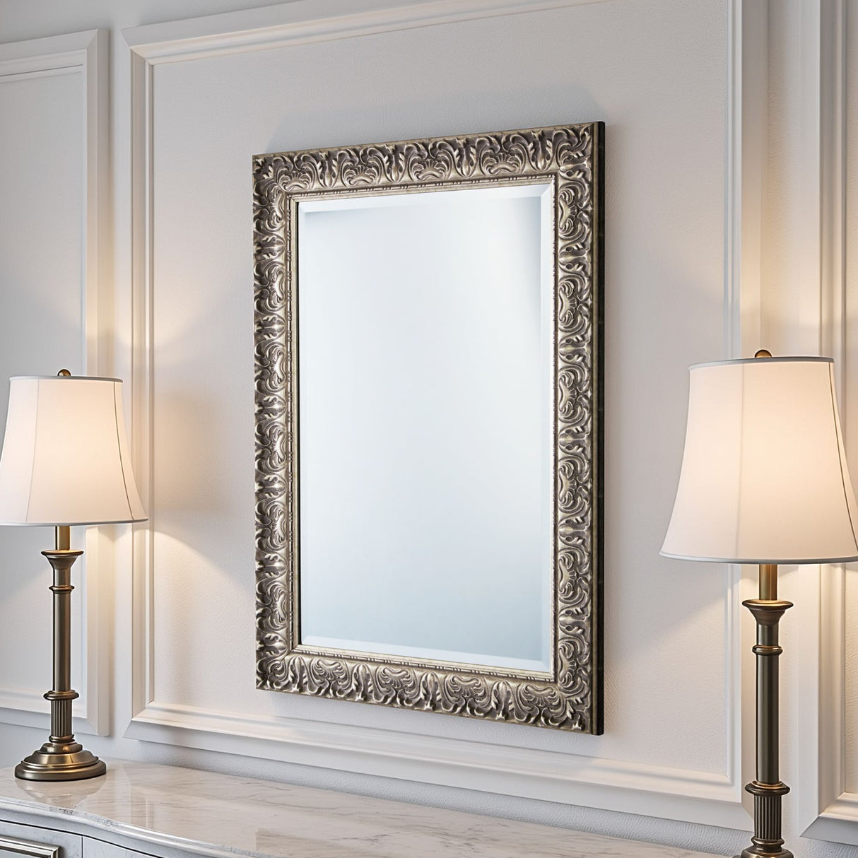 Decorative mirror with ornate frame on a wall with two lamps.