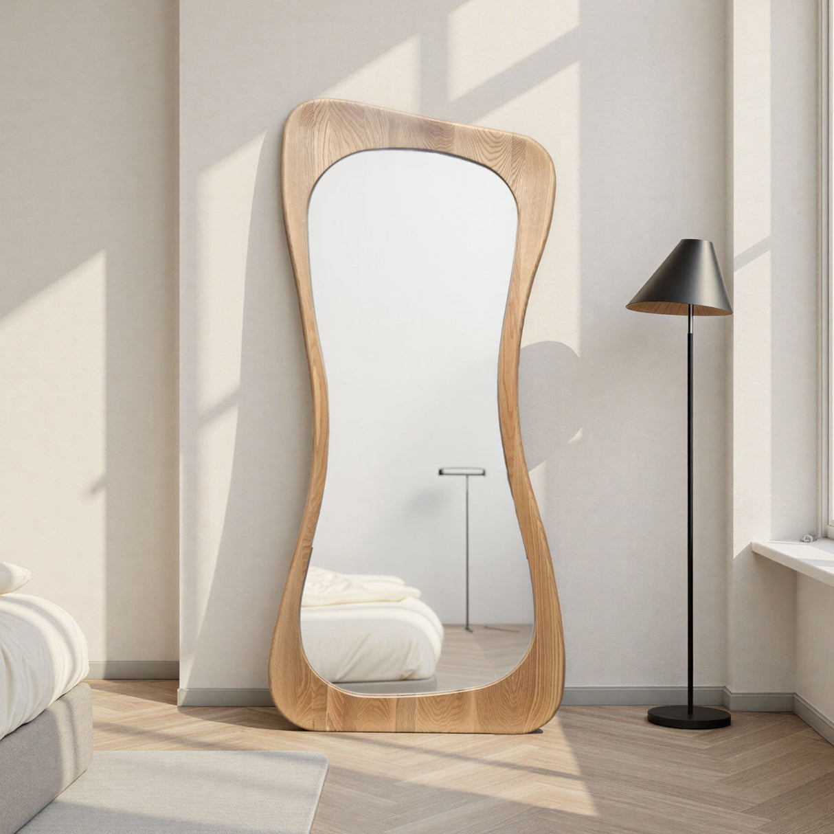 Wooden floor mirror in a room with a lamp and bed.