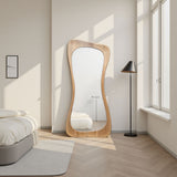 Modern room with a wavy wooden floor mirror, bed, and lamp.