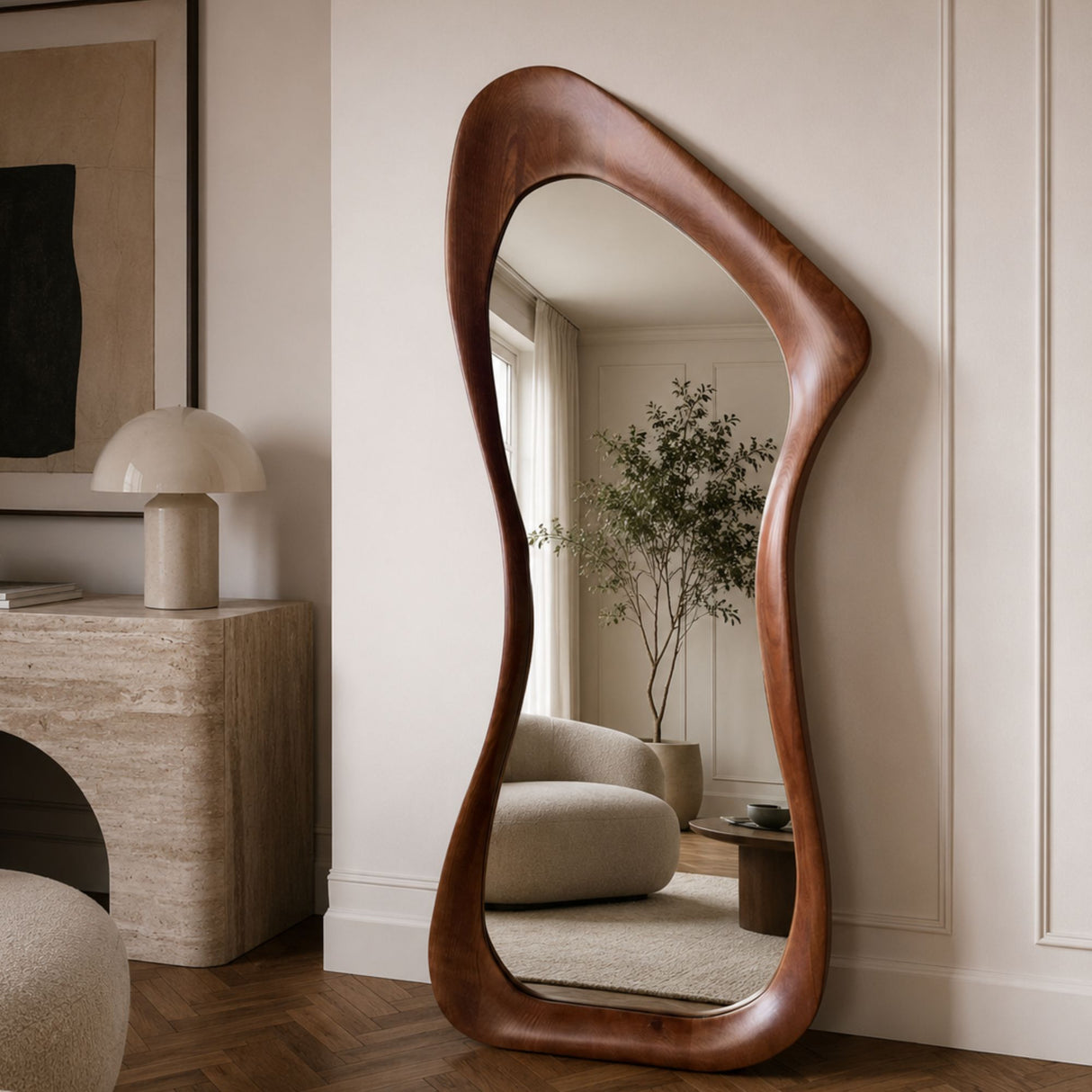 An organic-shaped full-length floor mirror with a rich, wavy brown wooden frame, styled in a warm, modern living room setting.
