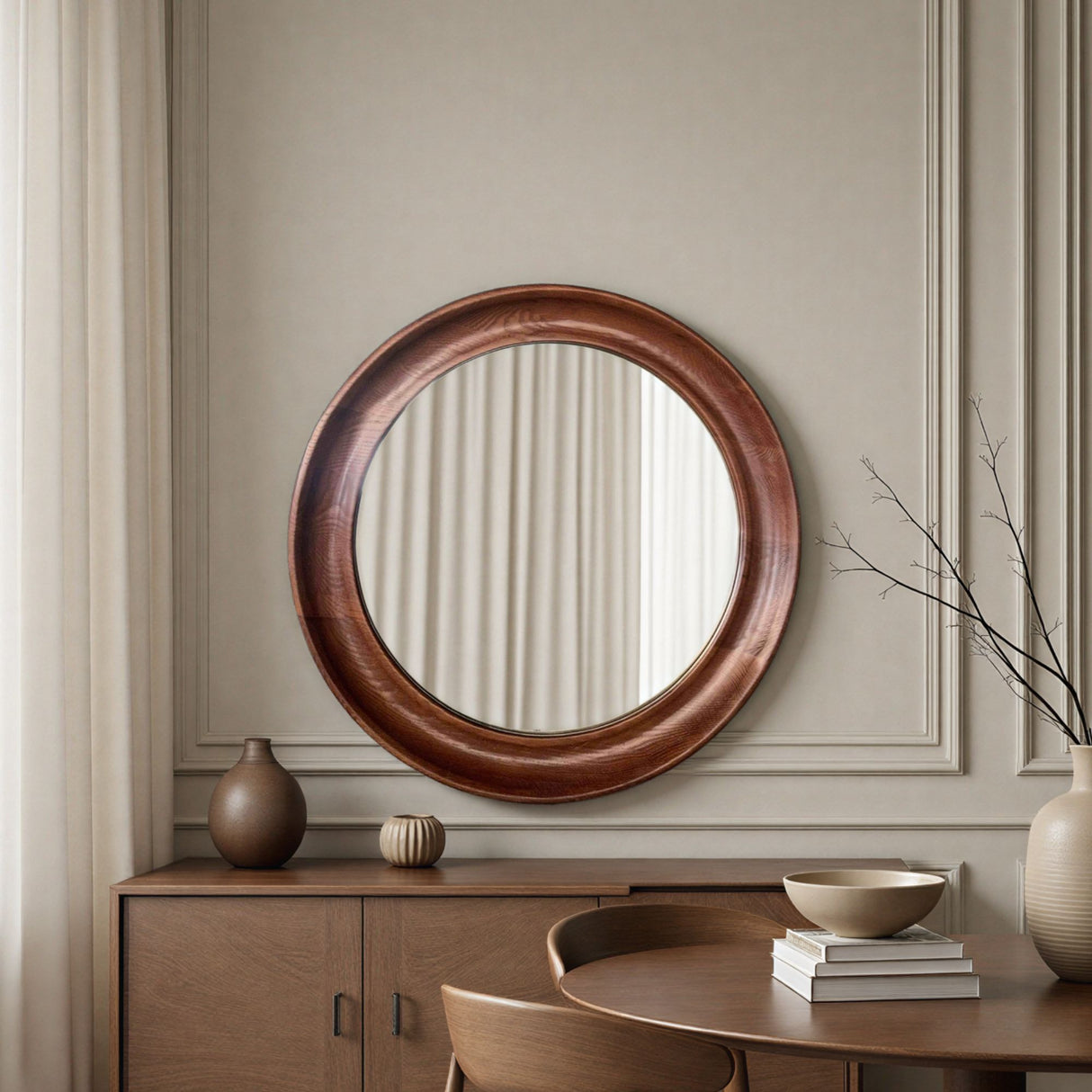 Round wooden mirror on a wall with a sideboard and decor items in a room.