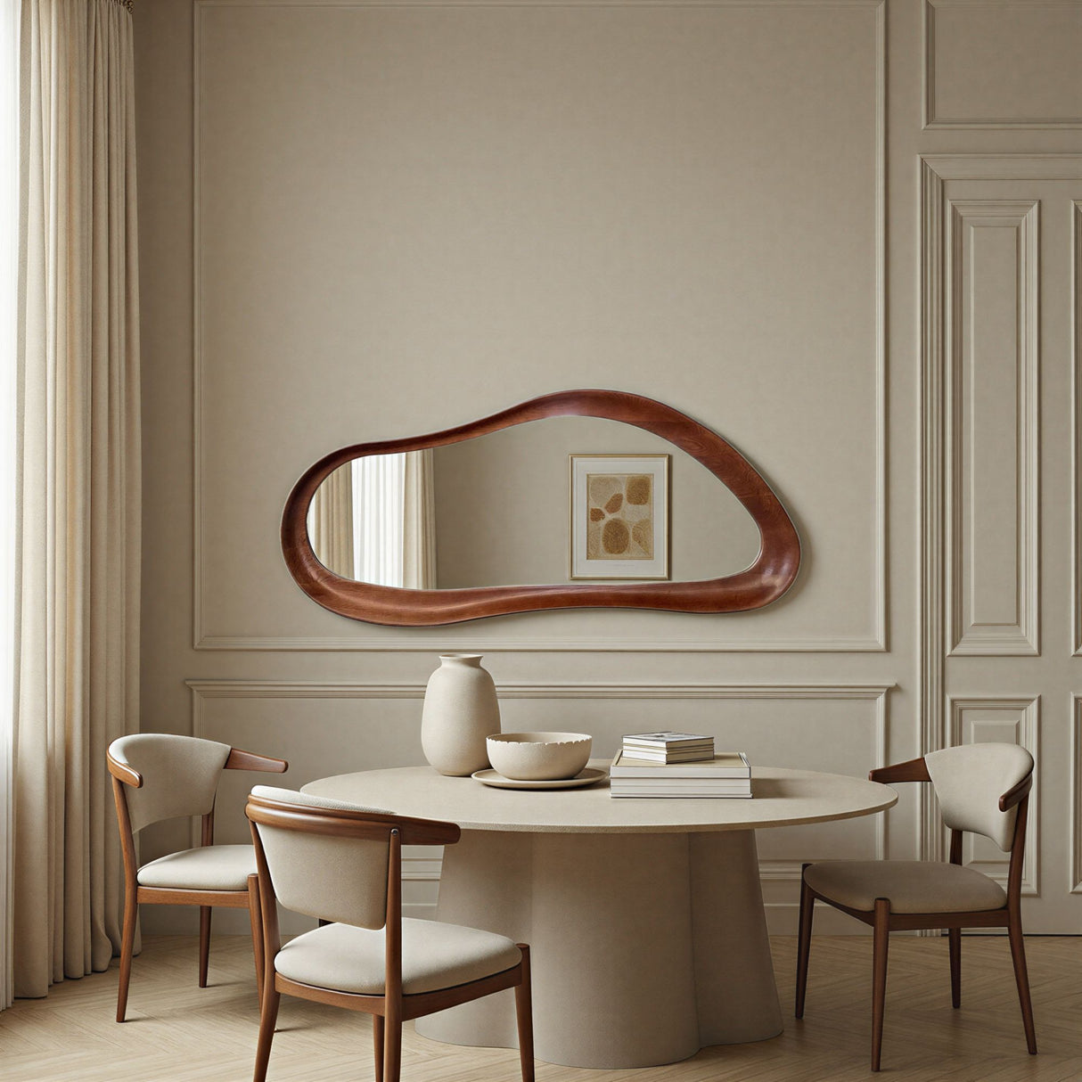 Dining room with a round table, chairs, and a large mirror on the wall.