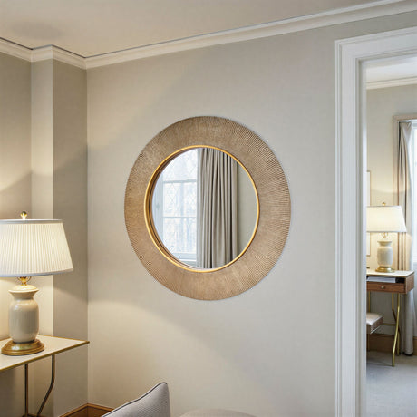 Round woven mirror on a wall with a lamp and curtain in the background