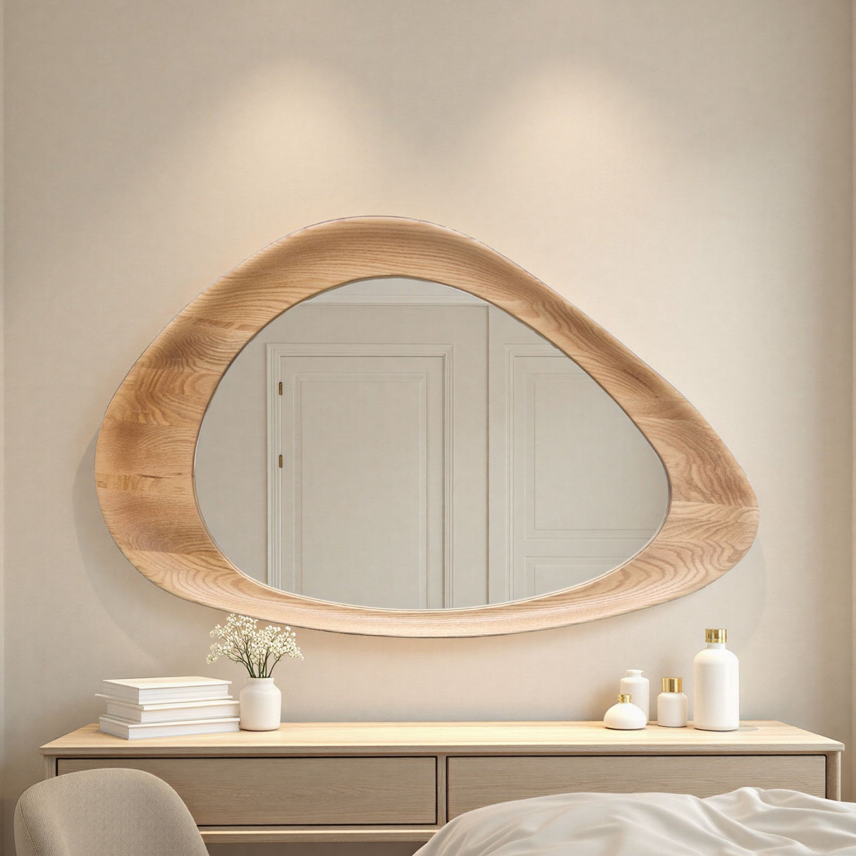 Wooden mirror on a wall above a dresser with decorative items.