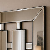 An elegant geometric wall mirror with a polished silver frame and inset square mirror details, mounted on a textured beige wall.