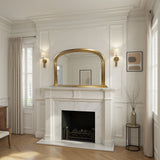 Neoclassical-style room with marble fireplace, gold-framed mirror, and decorative elements.