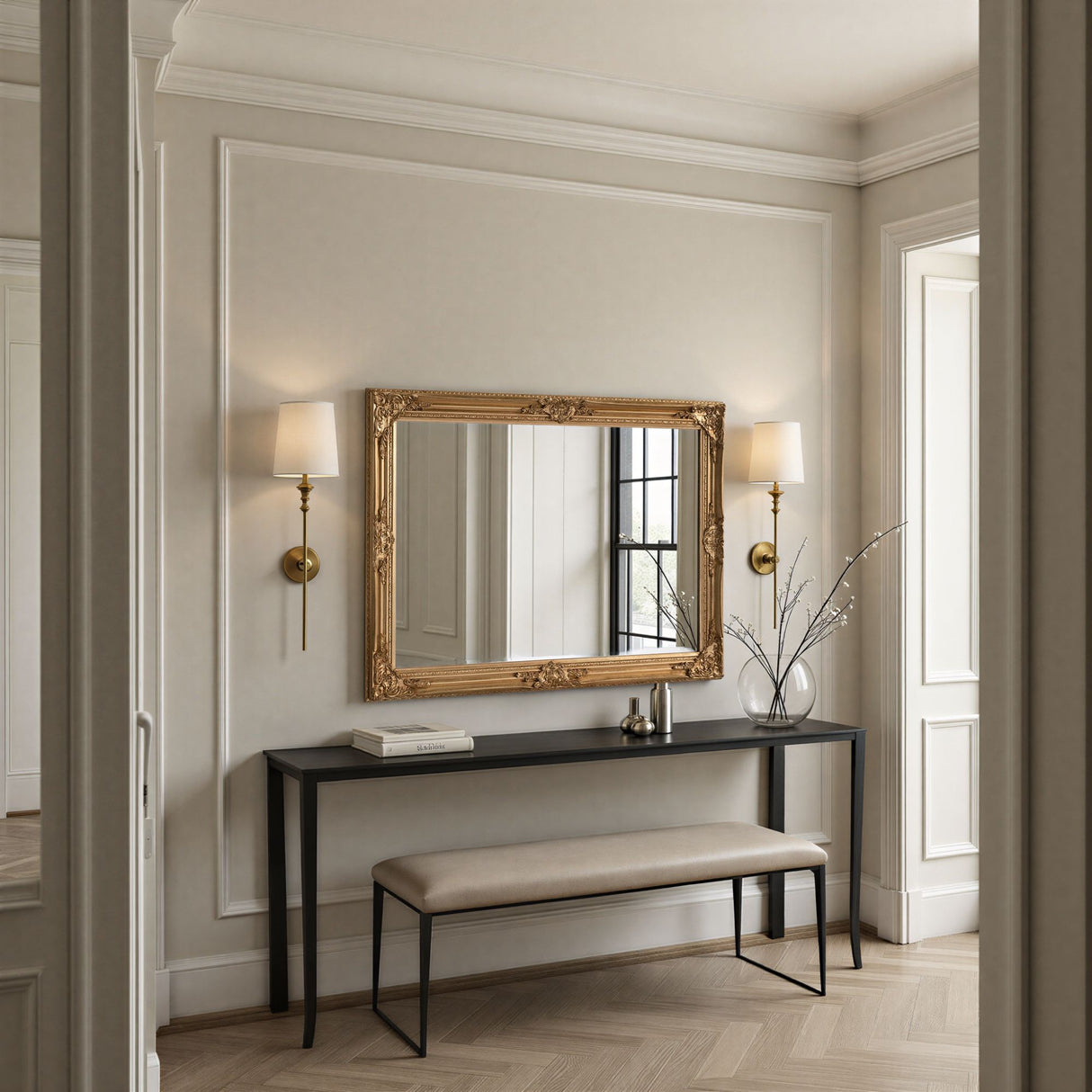 Decorative mirror with gold frame on a wall in a stylish interior setting.
