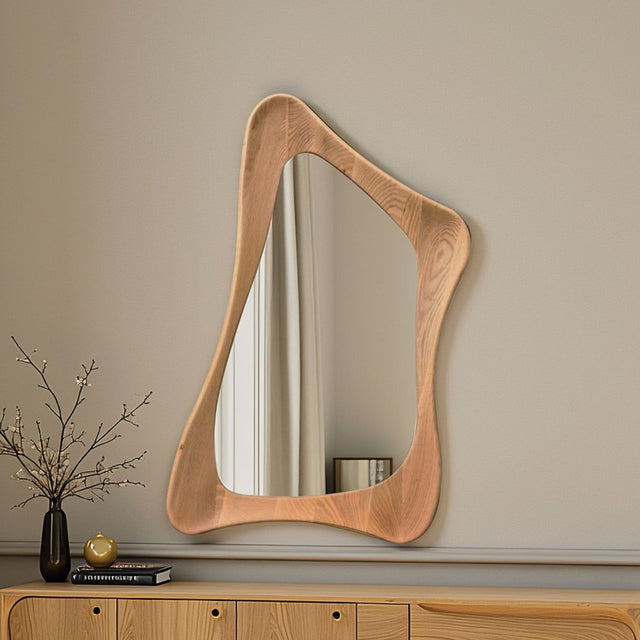 Wooden mirror with wavy frame on a beige wall
