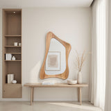 Modern interior with a wooden mirror and bench against a neutral wall.