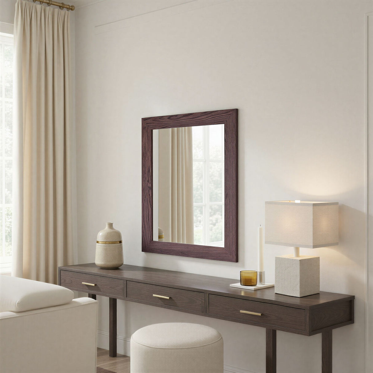 Wooden vanity with mirror, lamp, and decorative items in a bedroom setting.